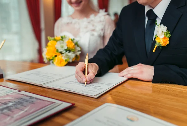 depositphotos_84637730-stock-photo-groom-signing-marriage-license